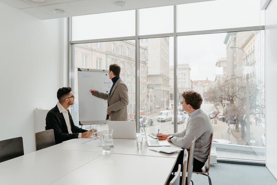 A diverse group of colleagues collaborating around a table in a bright, modern office.